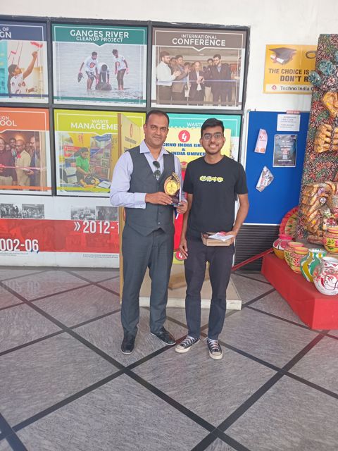 Guest speaker presenting an award to a student at Techno India Main Campus